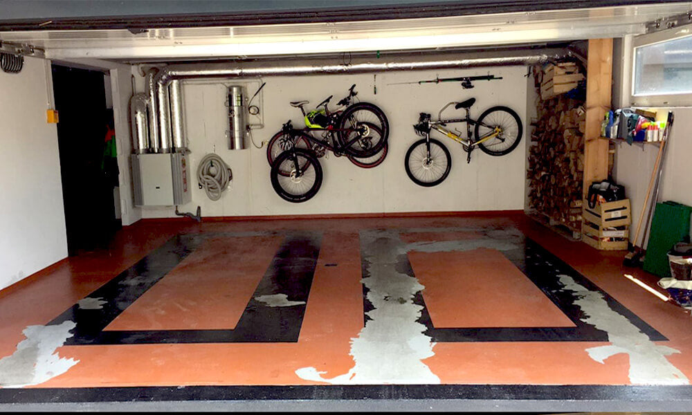 Dalles perforées AERO orange et blanches dans un garage avec vélos